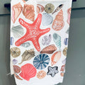 Towel with colorful shell and starfish pattern on a white background