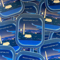 Stack of travel-themed products with Washington, DC skyline design