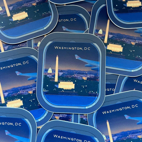 Stack of travel-themed products with Washington, DC skyline design