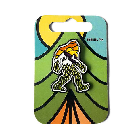 Colorful enamel pin with a design on a green backing card