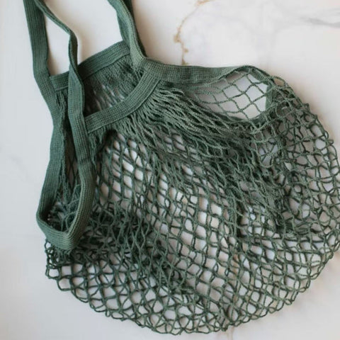 Green mesh bag on a marble surface