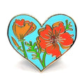 Heart-shaped pin with floral design on a white background