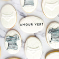 Decorative cookies with 'Amour Vert' branding on a marble surface