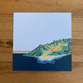 Artistic depiction of a leaf on a blue background, placed on a wooden surface.