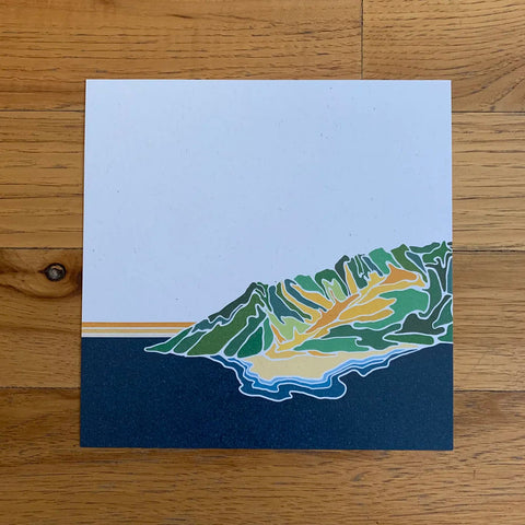 Artistic depiction of a leaf on a blue background, placed on a wooden surface.
