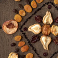 Assorted dried fruits on a wooden surface