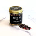 Jar of North Fork Tea Co. First Light Tea on a marble surface