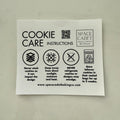 Sheet of cookie care instructions with Space Cadet Baking Company branding on a gray background