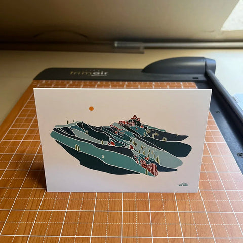 Card with mountain design on a cutting mat