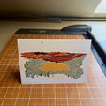 Card with landscape design on a cutting mat
