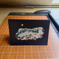 Card with mountain design on a cutting mat