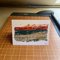 Card with mountain landscape design on a cutting mat