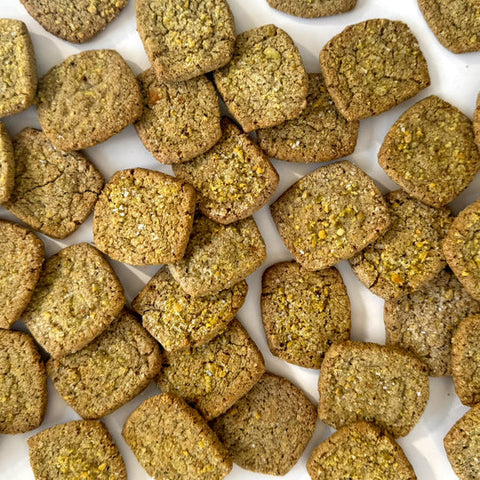 Close-up of green pet food pellets on a white background