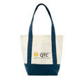A canvas tote bag with a cream-colored front and navy blue handles and bottom panel, featuring a printed logo for the 'Quantum Technical Community' on the front pocket.