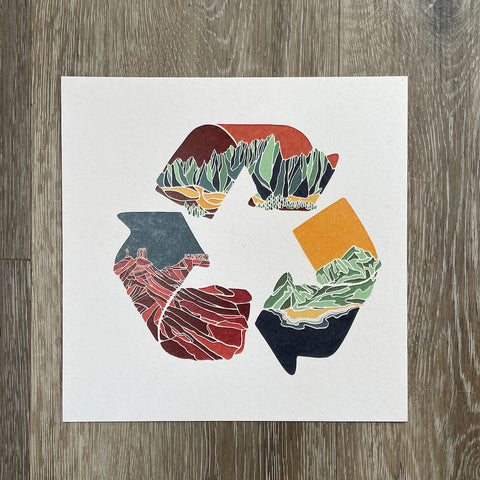 Colorful abstract design on a white square card against a wooden background