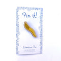 Wooden spoon-shaped pin on a 'Pin it!' card with decorative border