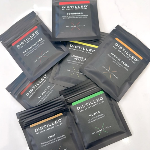 Collection of 'Distilled' spice packets on a white background