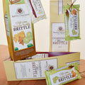 Anette's Chocolates Chili Lime Tequila and Chardonnay Wine Brittle packaging on a wooden surface.