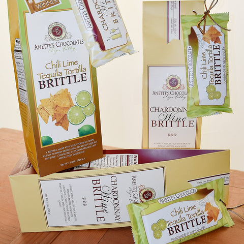 Anette's Chocolates Chili Lime Tequila and Chardonnay Wine Brittle packaging on a wooden surface.