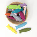 Colorful fish-shaped toys in a woven basket on a white background