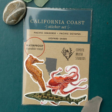 Packaging of California Coast stickers featuring a seahorse, octopus, and shark on a teal background.