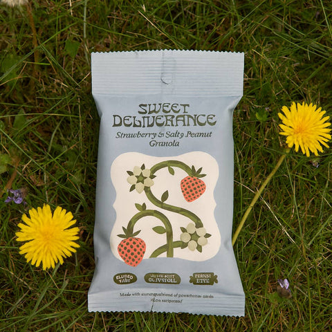 Sweet Deliverance granola packet on grass with dandelions