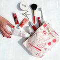 Cosmetic bag with beauty products on a white background