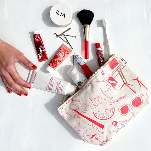 Cosmetic bag with beauty products on a white background