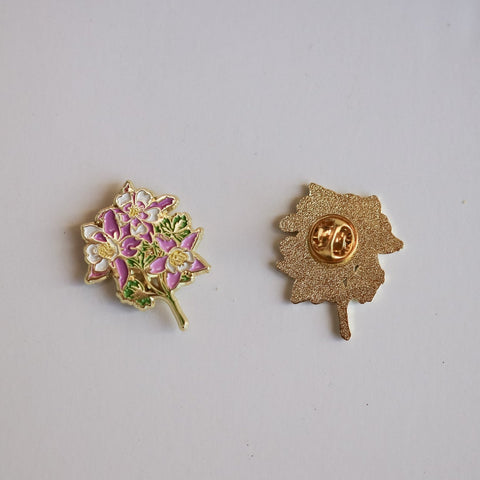 Two decorative pins on a light gray background