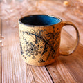 Ceramic mug with decorative design on a wooden surface