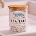 Jar of Florida Pure Sea Salt with a wooden lid on a light background