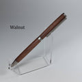 A wooden pen with a dark walnut finish and silver metal accents, displayed on a clear acrylic stand against a neutral gray background. The word 'Walnut' is printed in black text on the left side.