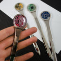 Metallic spoons with electronic components on a white surface