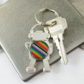 Keychain with rainbow design attached to a set of keys on a metallic surface.