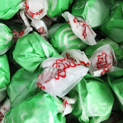Close-up of green and white striped candies with red text