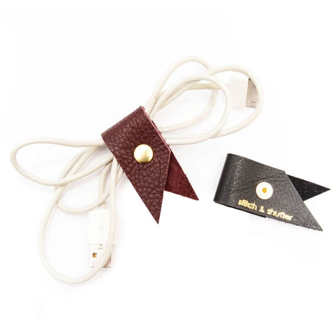Leather lanyard with a small flag attachment on a white background