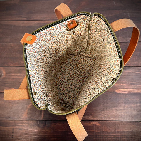 Backpack with patterned interior on a wooden surface