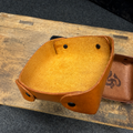Brown leather bracelet on a wooden surface