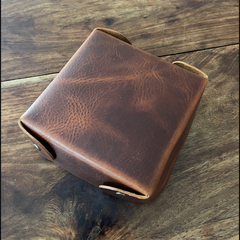 Brown leather wallet on a wooden surface