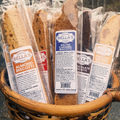 Basket filled with packages of Bella's biscotti with visible labels.