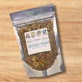 Packaged spice mix labeled 'Vegas Heat' on a wooden surface
