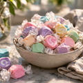 Bowl of colorful taffy candies on a marble surface with a blurred background