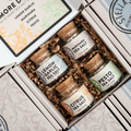 Three jars of sea salt in a decorative box with 'More Di Mano' branding.