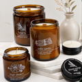 Collection of apothecary candles with labels on a white surface