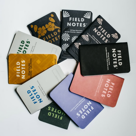 Collection of Field Notes notebooks in various colors on a light background
