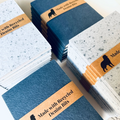 Stacks of notebooks made with recycled denim bits on a white background