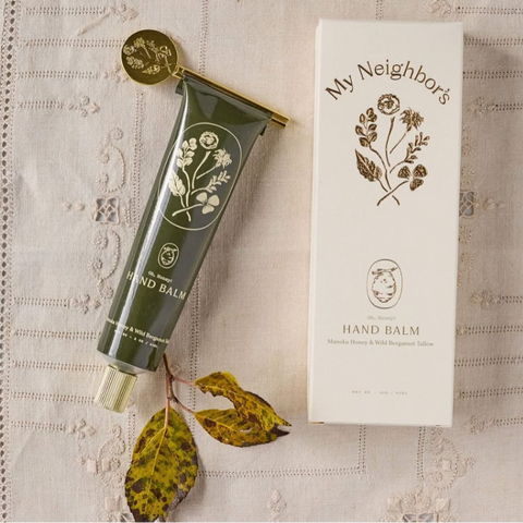Hand balm tube and packaging on a textured fabric background