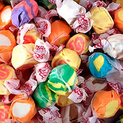 Assorted colorful taffy candies in clear wrappers.