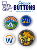Collection of colorful pinback buttons with various designs on a white background, featuring the brand 'Poppy and Quail'.